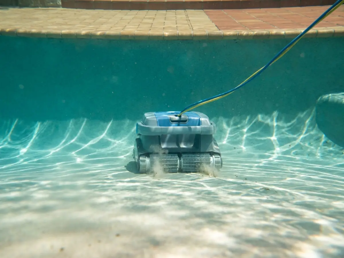 Robotic pool cleaner working along the floor of a pool